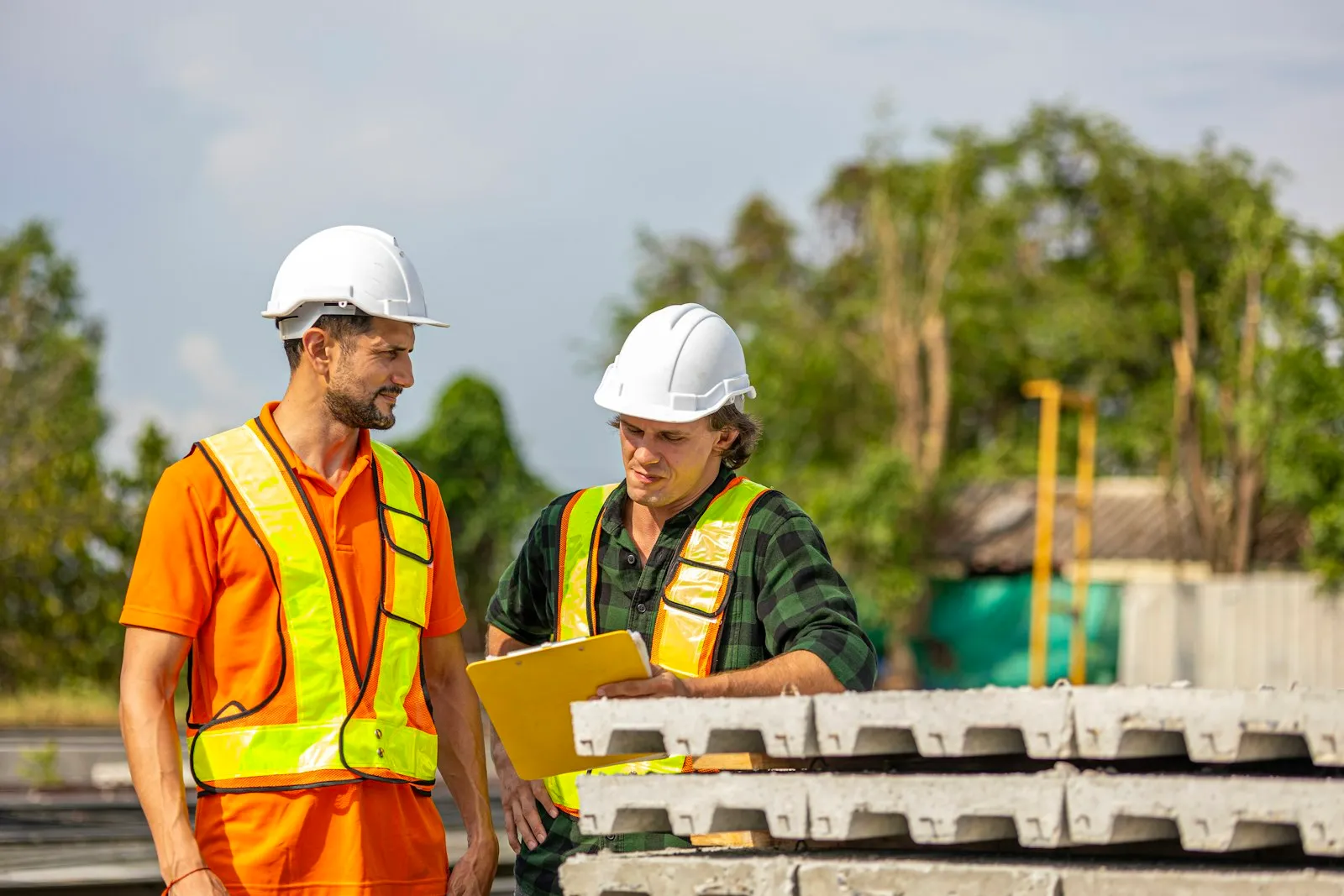 Project professionals reviewing plans together on a construction site